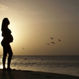 beautiful young, pregnant woman, in beach