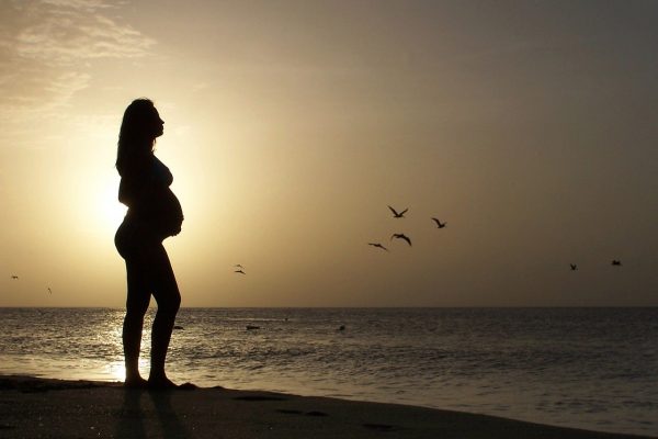 beautiful young, pregnant woman, in beach